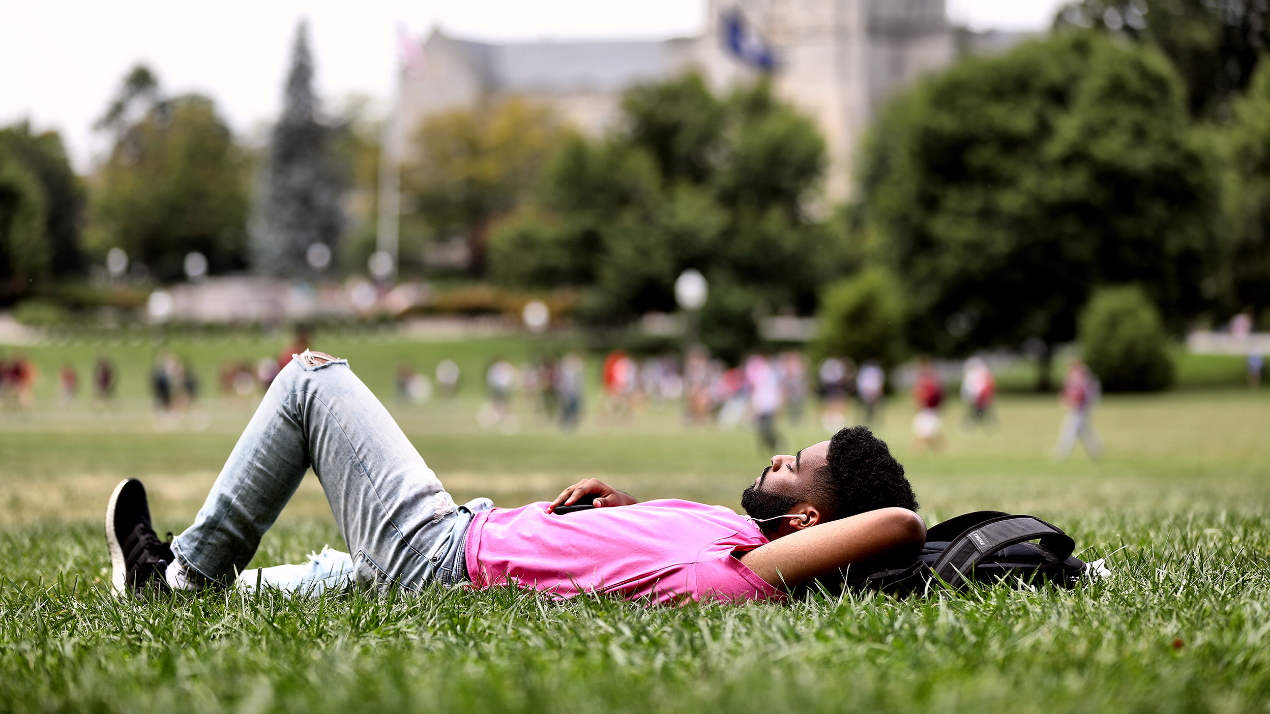 Student taking a nap on the drillfield 